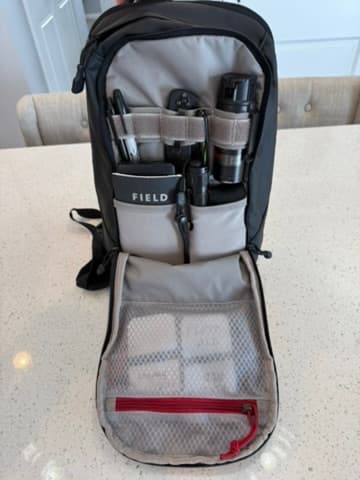 Front compartment of a sling bag organized with everyday carry tools